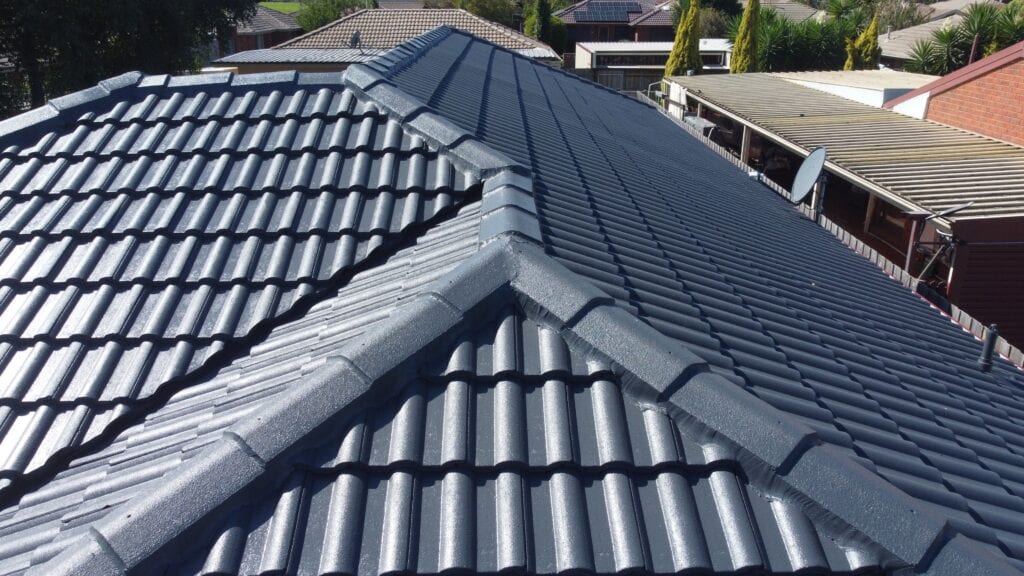 Charcoal-coated tiled roof with freshly pointed hips and ridges meeting