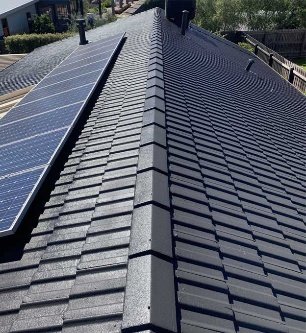 The same roof after charcoal coating, solar array still in place