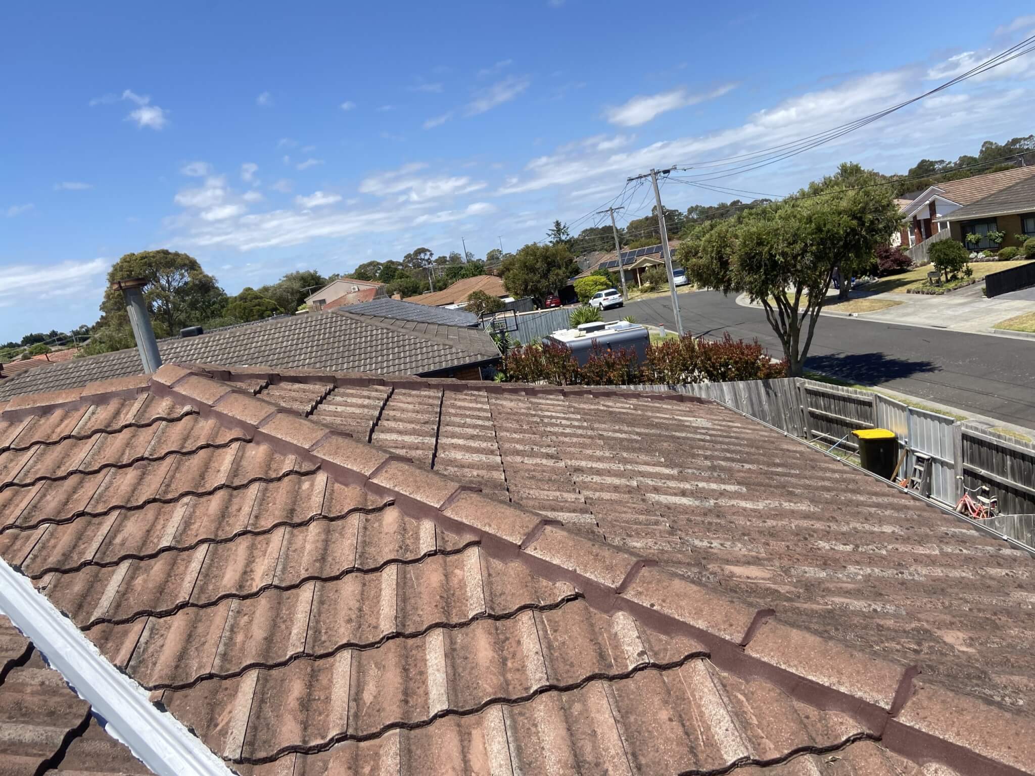Dirty brown tiled roof photographed from the ridge